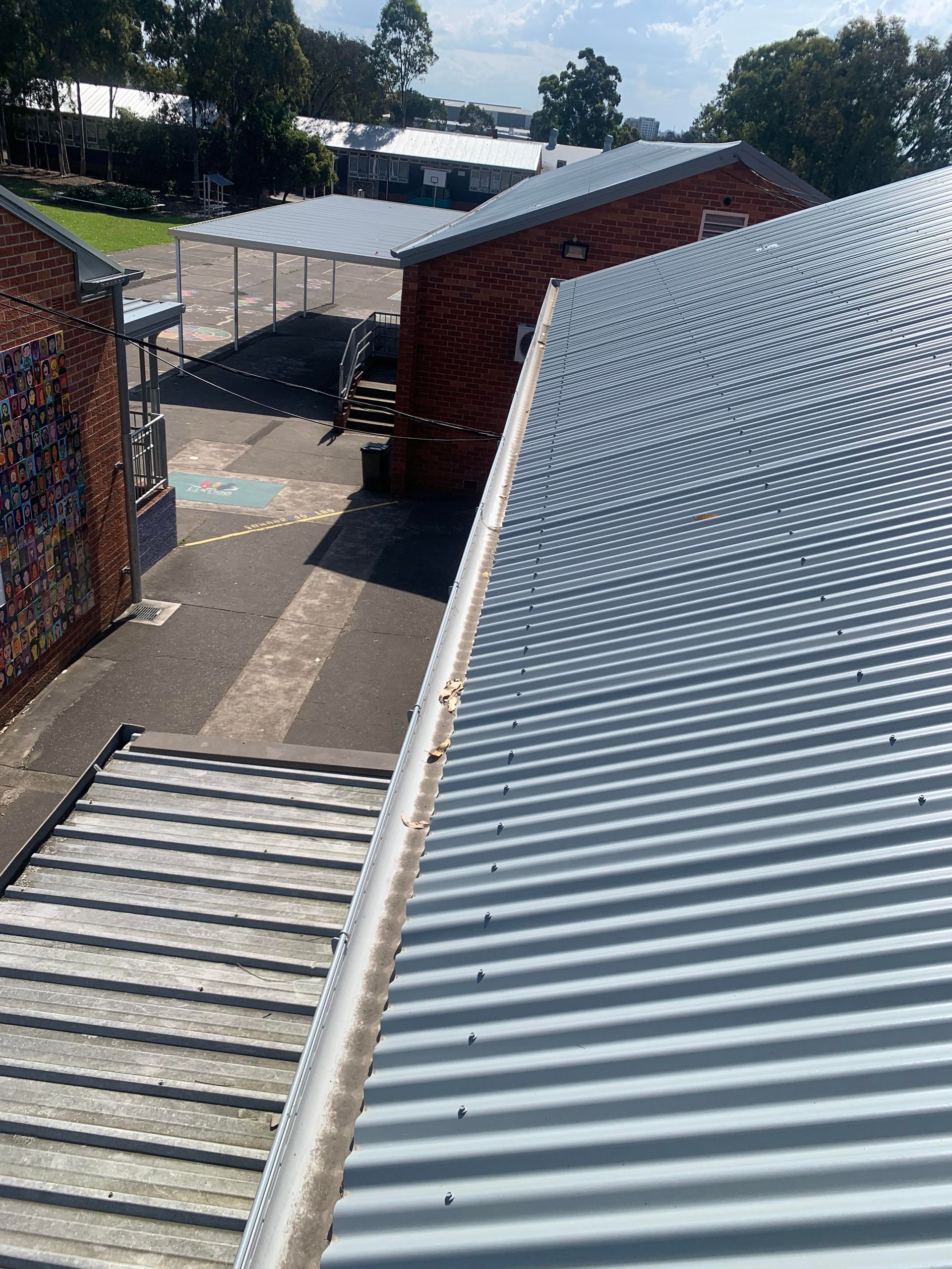 An Aerial View Of A School Building Roof— Kimick Roofing Solutions In Wyong, NSW