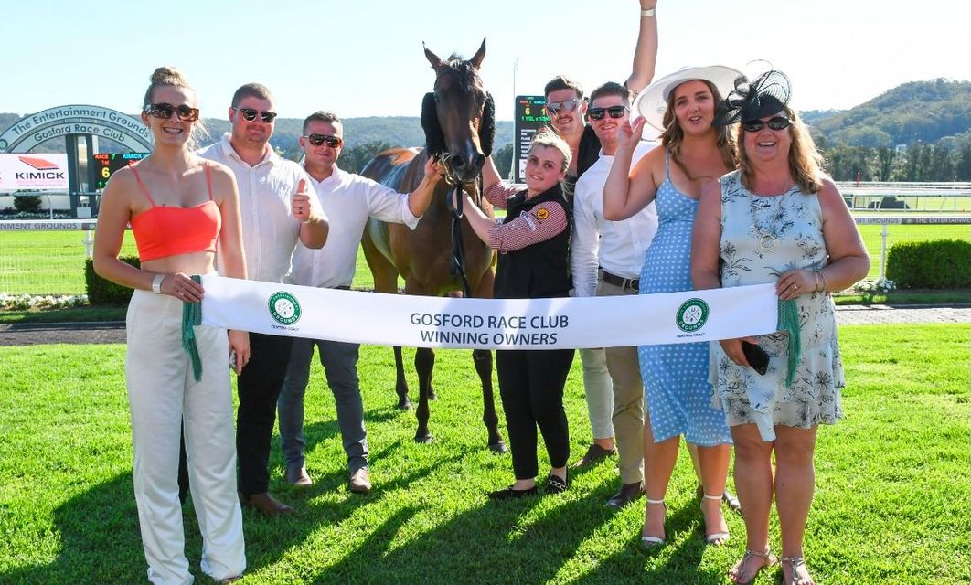 A group of people standing around a horse holding a ribbon — Kimick Roofing Solutions In Wyong, NSW