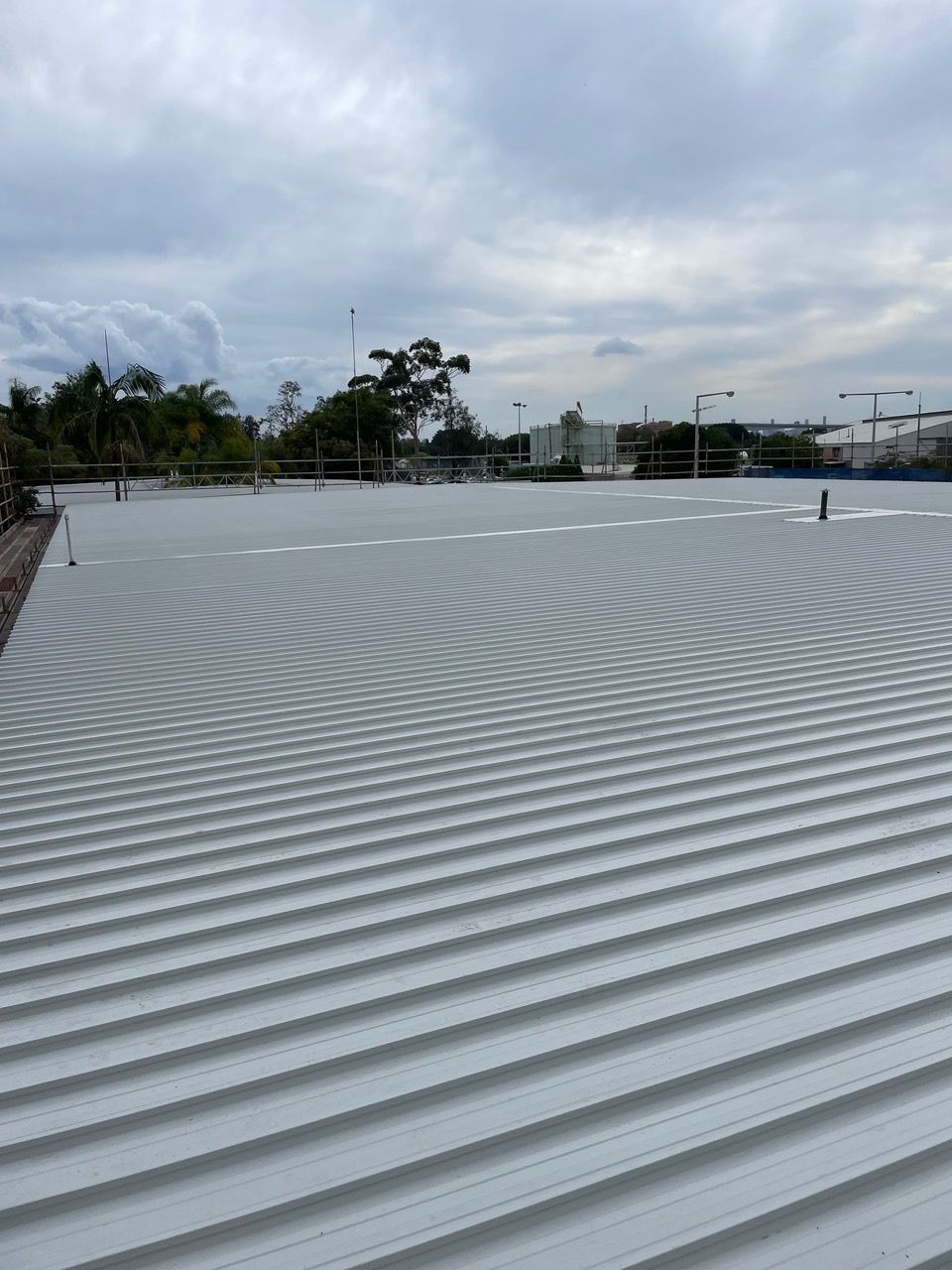 Two Man Working On Top Of The Roof With Scaffolding — Kimick Roofing Solutions In Wyong, NSW