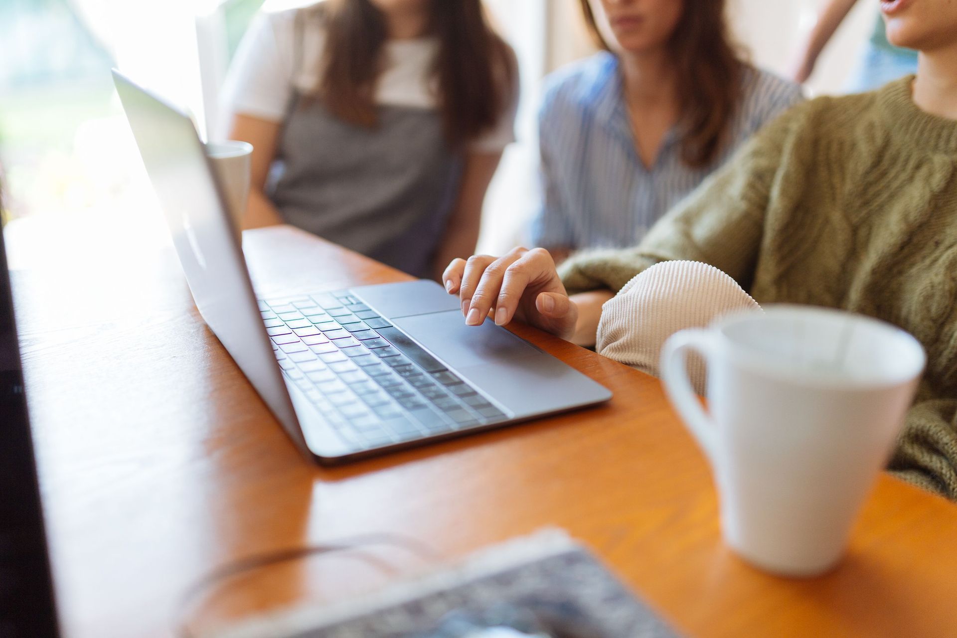 SheCounts LLC team member reviewing financial statements at Salt Lake City office desk