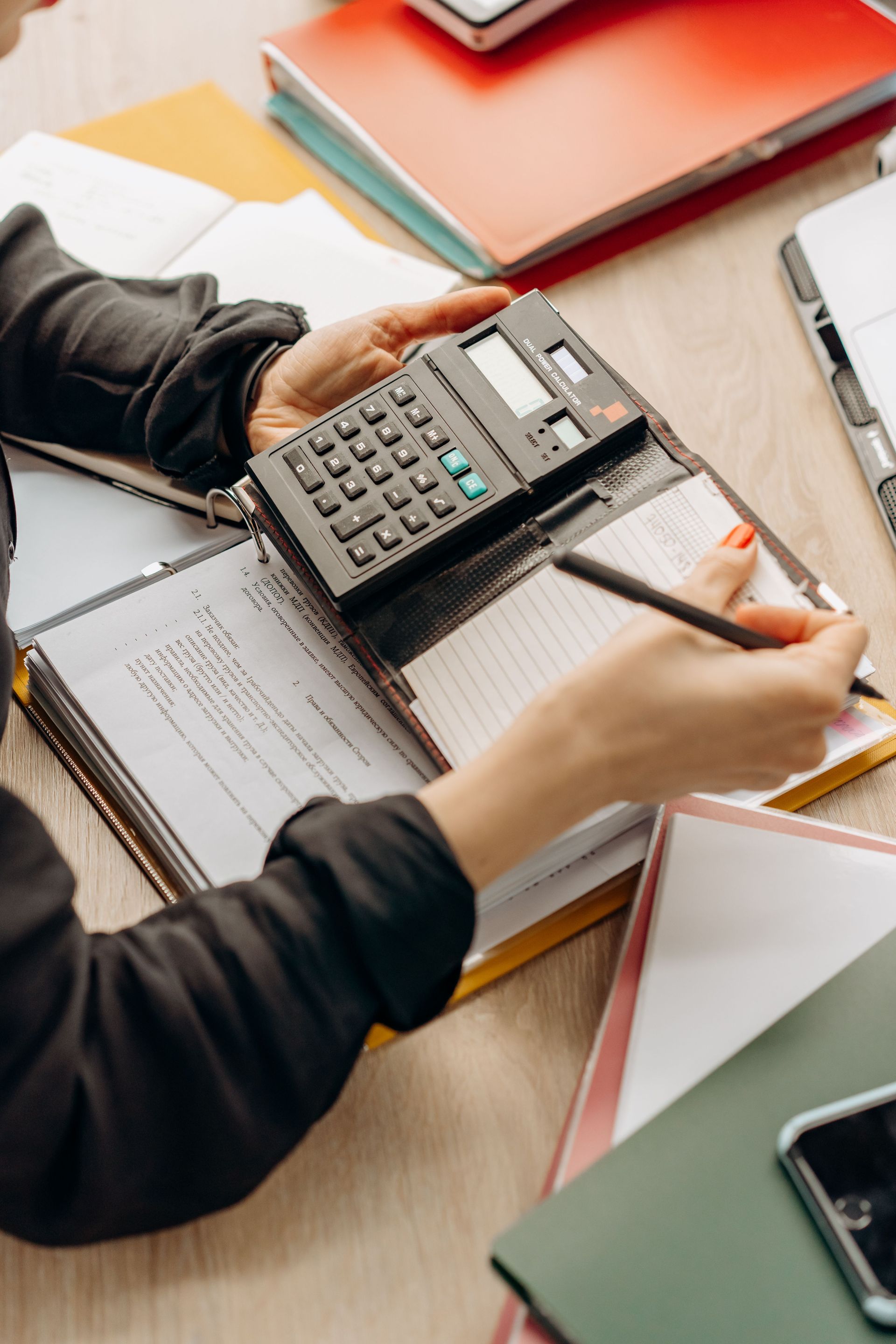 SheCounts LLC team member reviewing financial statements at Salt Lake City office desk