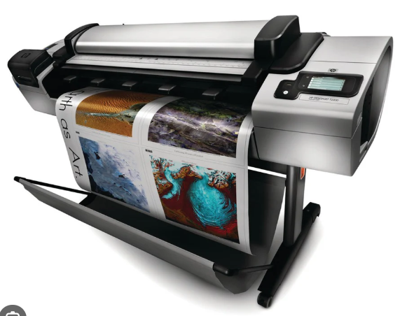 Large-format printer producing a colorful banner print on a roll