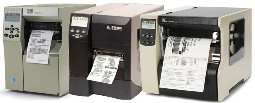 Three industrial label printers printing shipping labels in a row