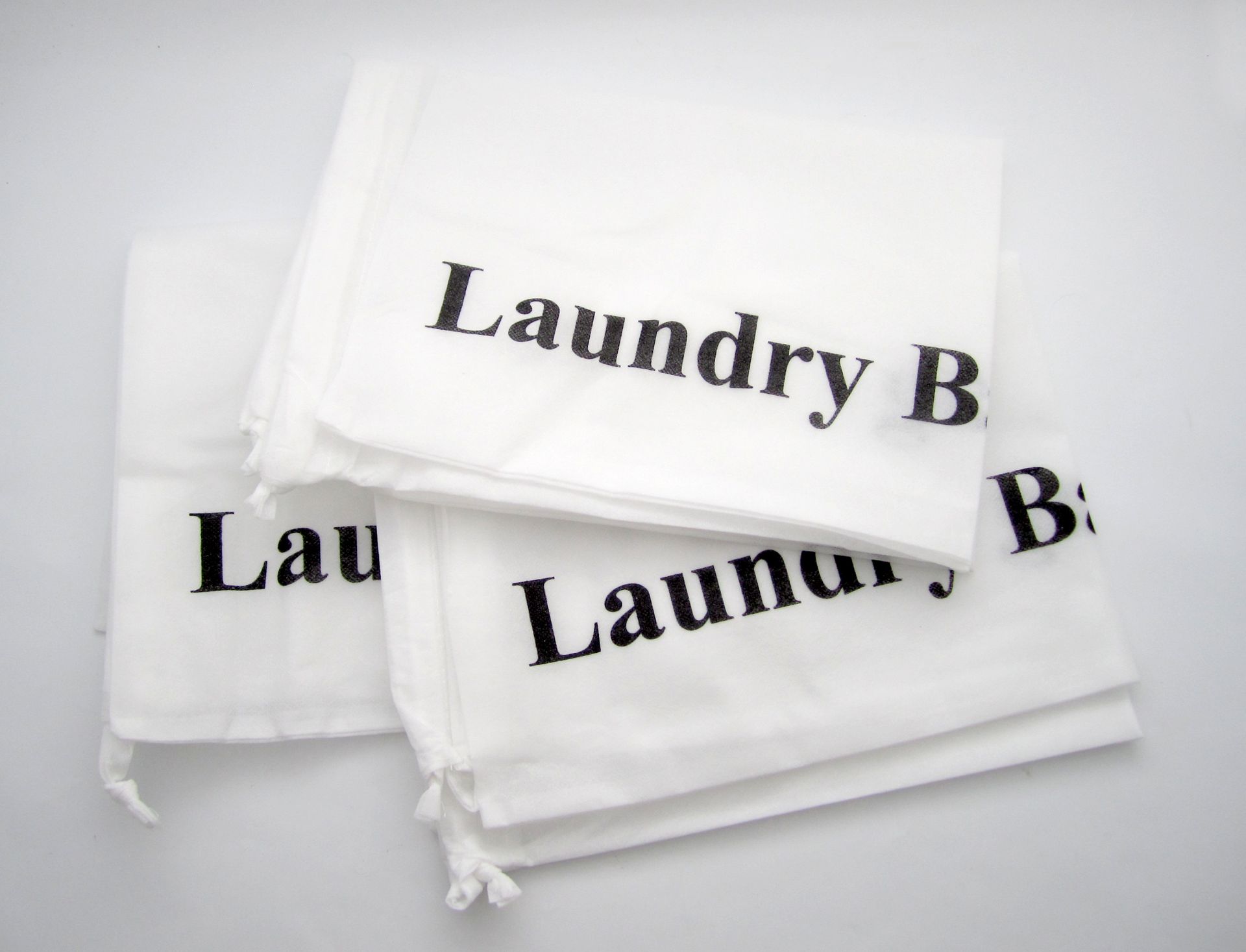 White laundry bags with black text