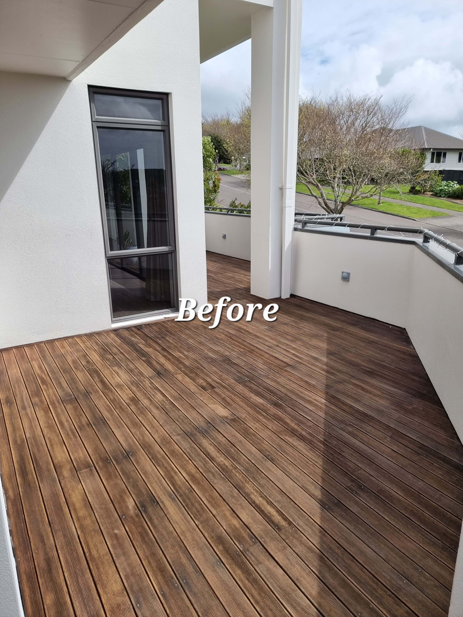 Wooden balcony deck with white walls and railing, labeled “Before”