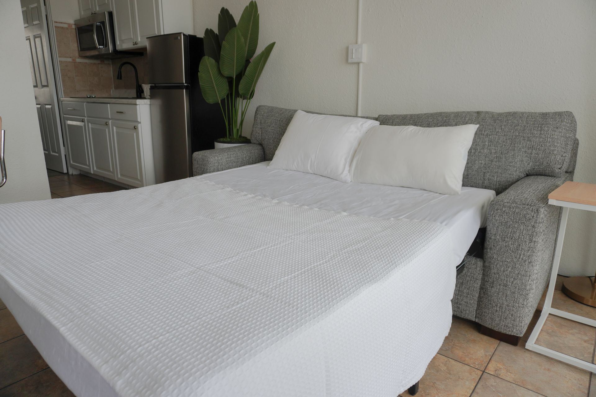 There is a couch that has been converted into a bed.