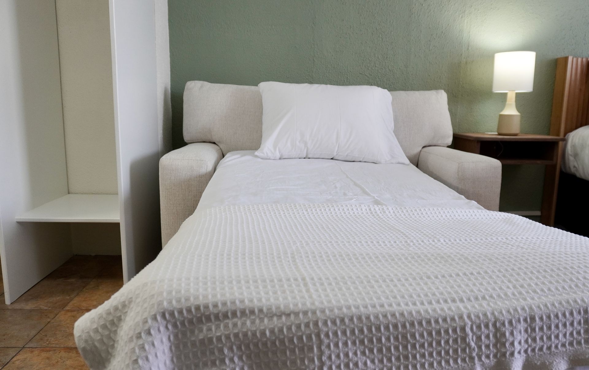 A couch that has been converted into a bed