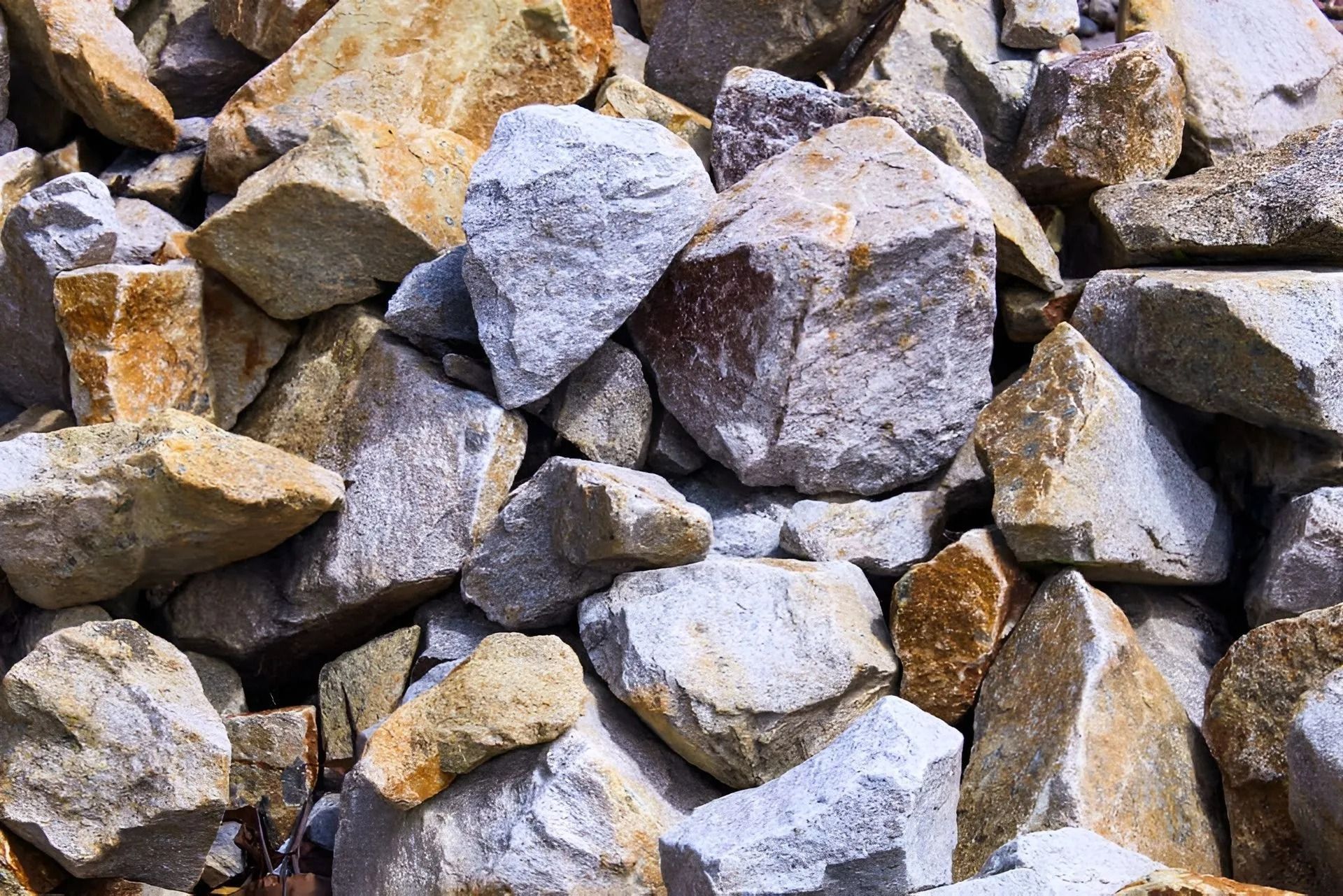 Pile of Rough-cut Rocks in Shades of Tan, Brown, and Grey — Blue Dog Earthmoving Landscape Supplies in Nambucca Heads, NSW