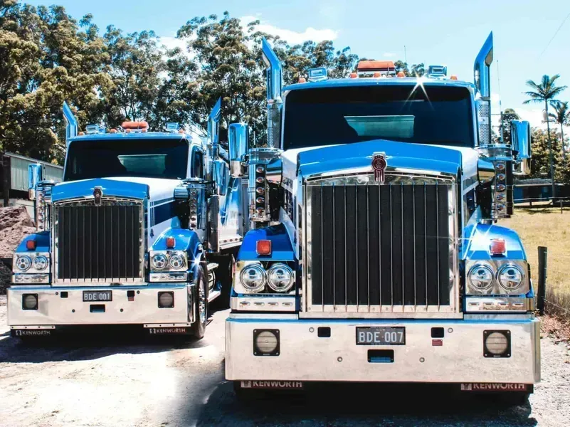 Two Blue Kenworth Semi-trucks Parked on Dirt, — Blue Dog Earthmoving Landscape Supplies in Newee Creek, NSW