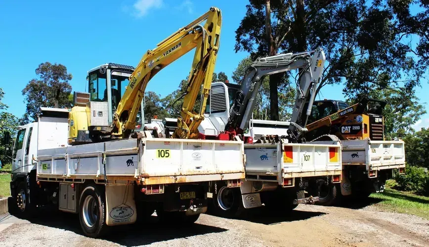 Three Flatbed Trucks Loaded With Construction Excavators — Blue Dog Earthmoving Landscape Supplies in Bowraville, NSW