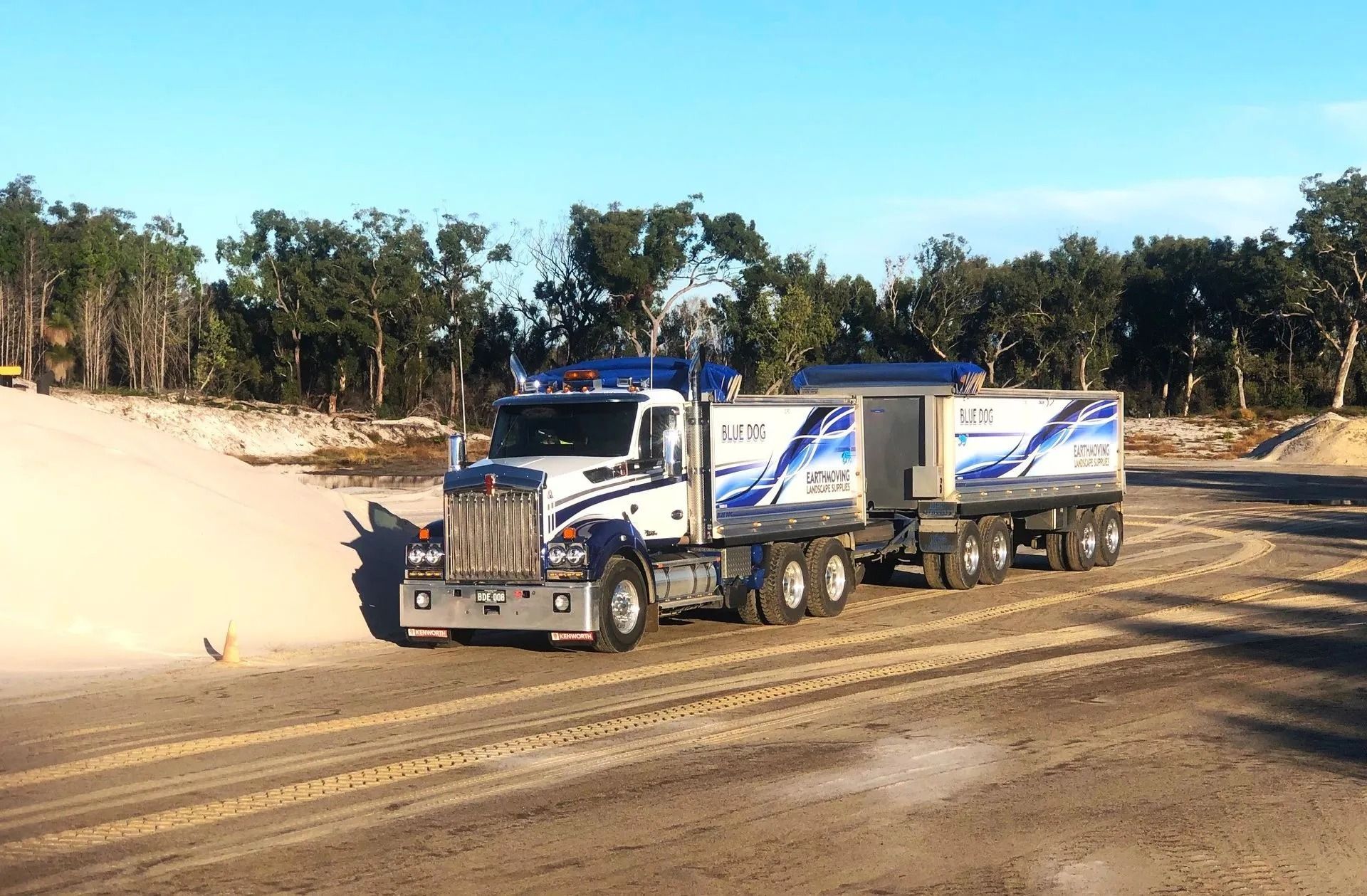 White And Blue Semi-truck On A Dirt Road — Blue Dog Earthmoving Landscape Supplies in Newee Creek, NSW