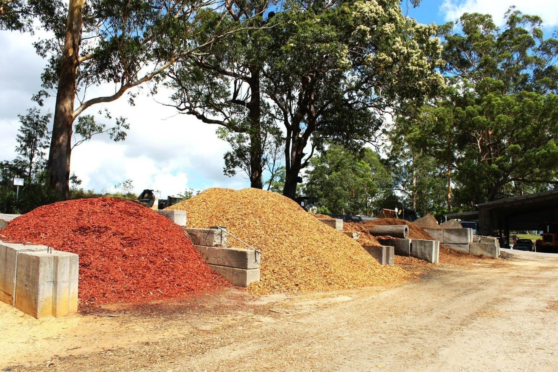 Piles of Red and Tan Mulch at a Landscape Supply Yard — Blue Dog Earthmoving Landscape Supplies in Newee Creek, NSW