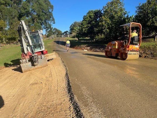 Road Construction With Excavator and Roller on a Dirt Road — Blue Dog Earthmoving Landscape Supplies in Newee Creek, NSW
