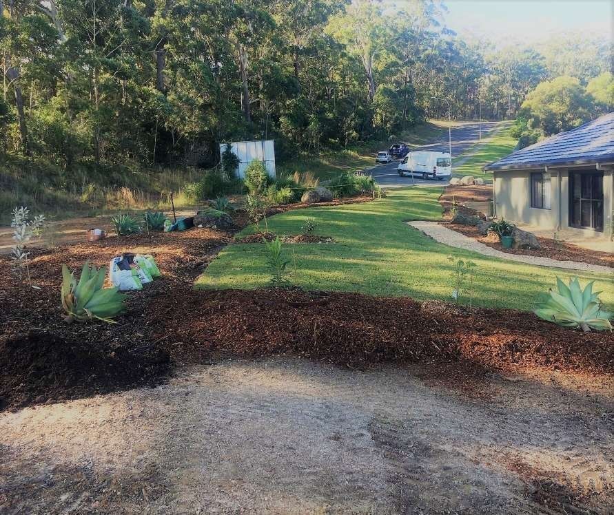 Yard With Garden Beds, Grass, and a House — Blue Dog Earthmoving Landscape Supplies in Newee Creek, NSW