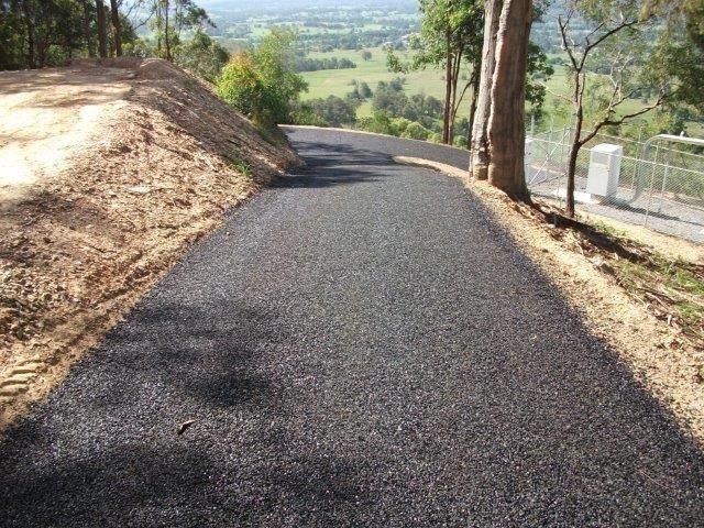 Paved Asphalt Road Curving Uphill, Flanked by Dirt Banks — Blue Dog Earthmoving Landscape Supplies in Newee Creek, NSW