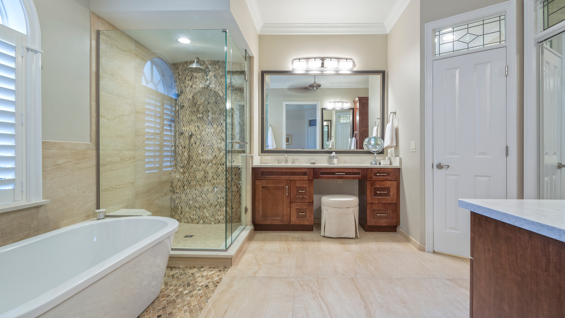 A bathroom with a tub , sink , mirror and walk in shower.