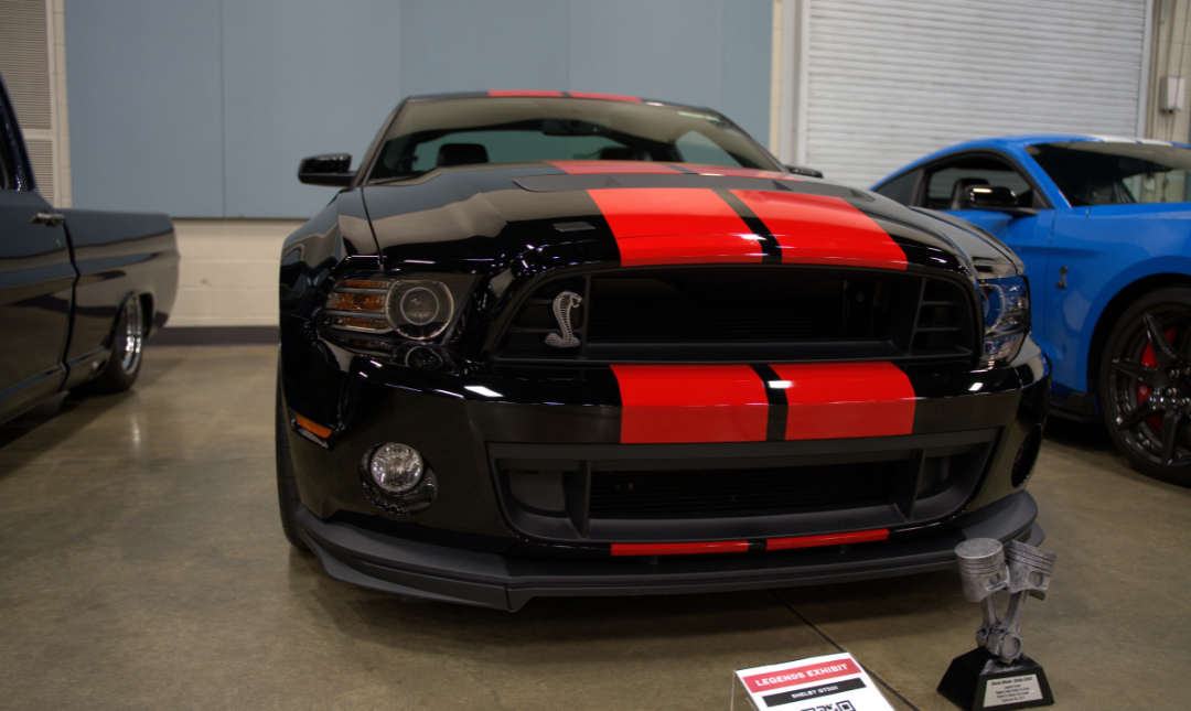 Black Shelby sports car with dual red hood stripes