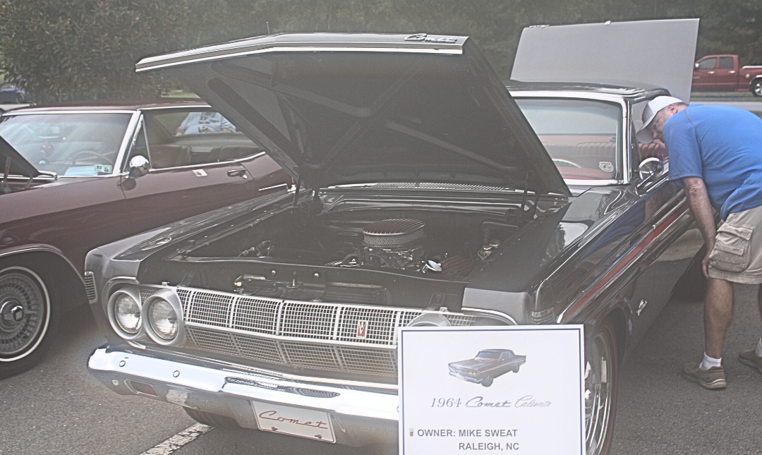 black antique car with raised hood & trunk