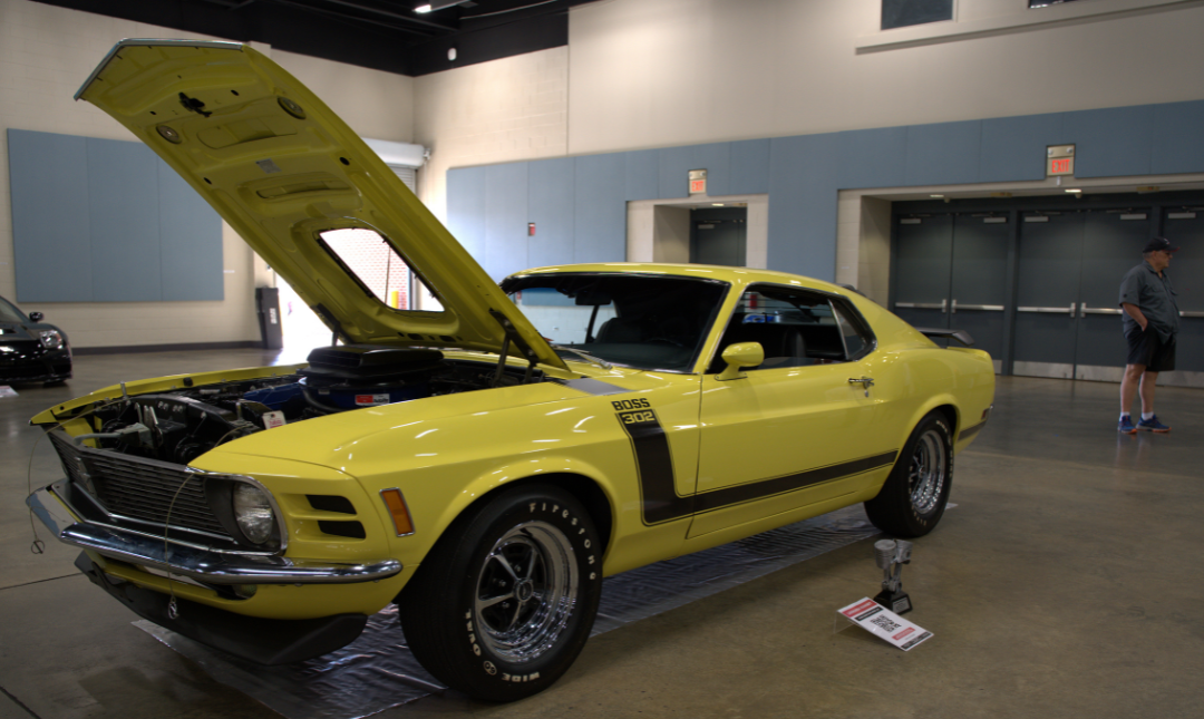 Yellow muscle car with hood raised