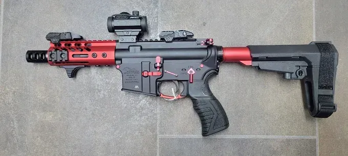 A photo of red and black gun