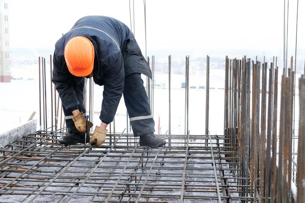 Construction Worker in Orange Hardhat Bending — Northern Rivers Concrete Construction in Pimlico, NSW