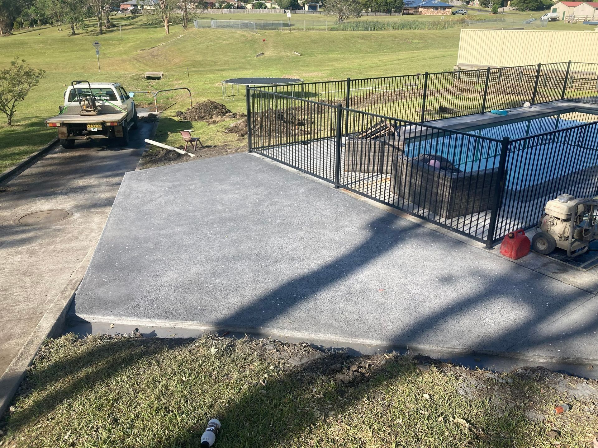 Flatbed Truck Parked Next to a Concrete Patio — Northern Rivers Concrete Construction in Pimlico, NSW