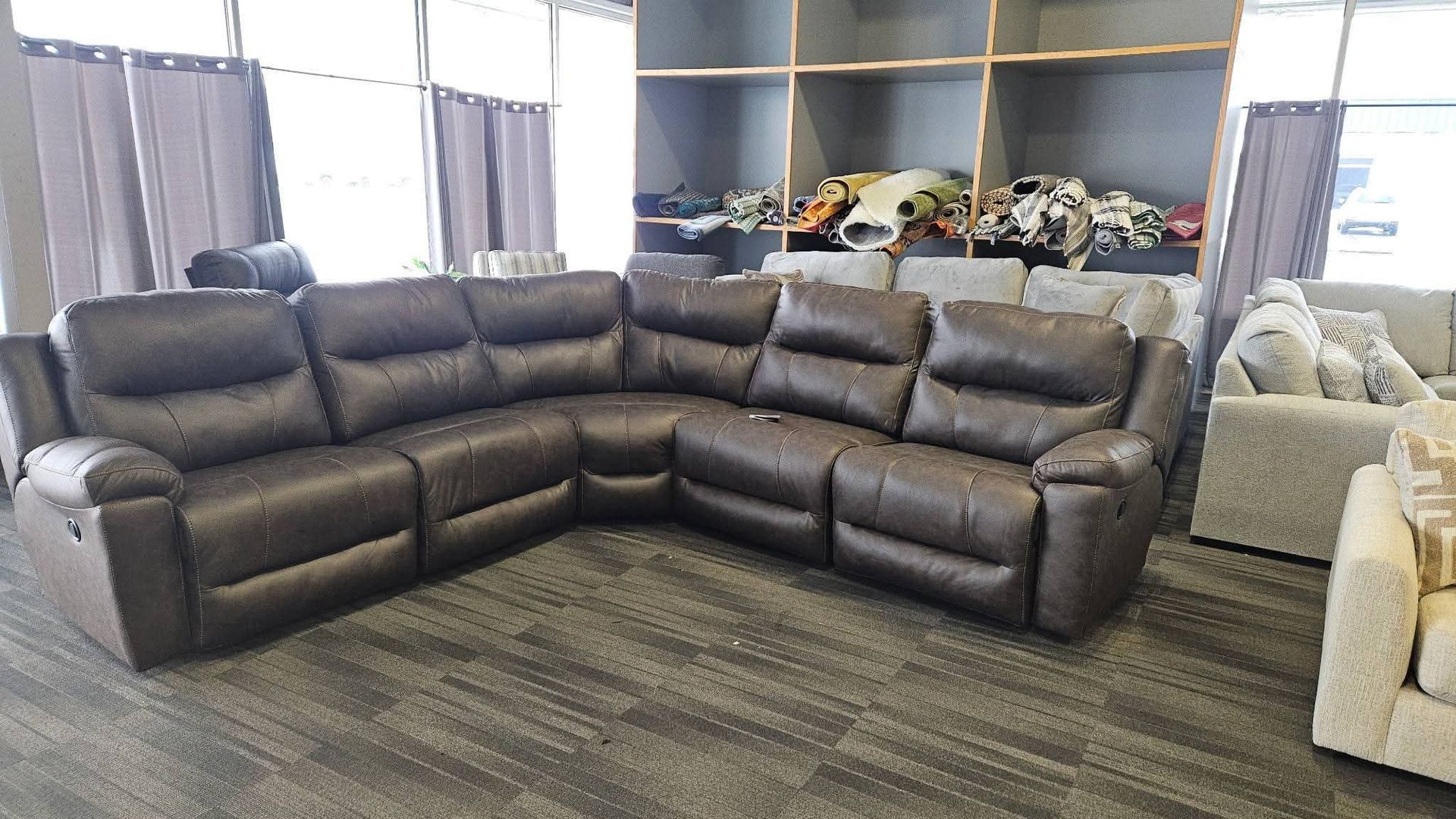 Dark brown leather sectional sofa in a showroom.