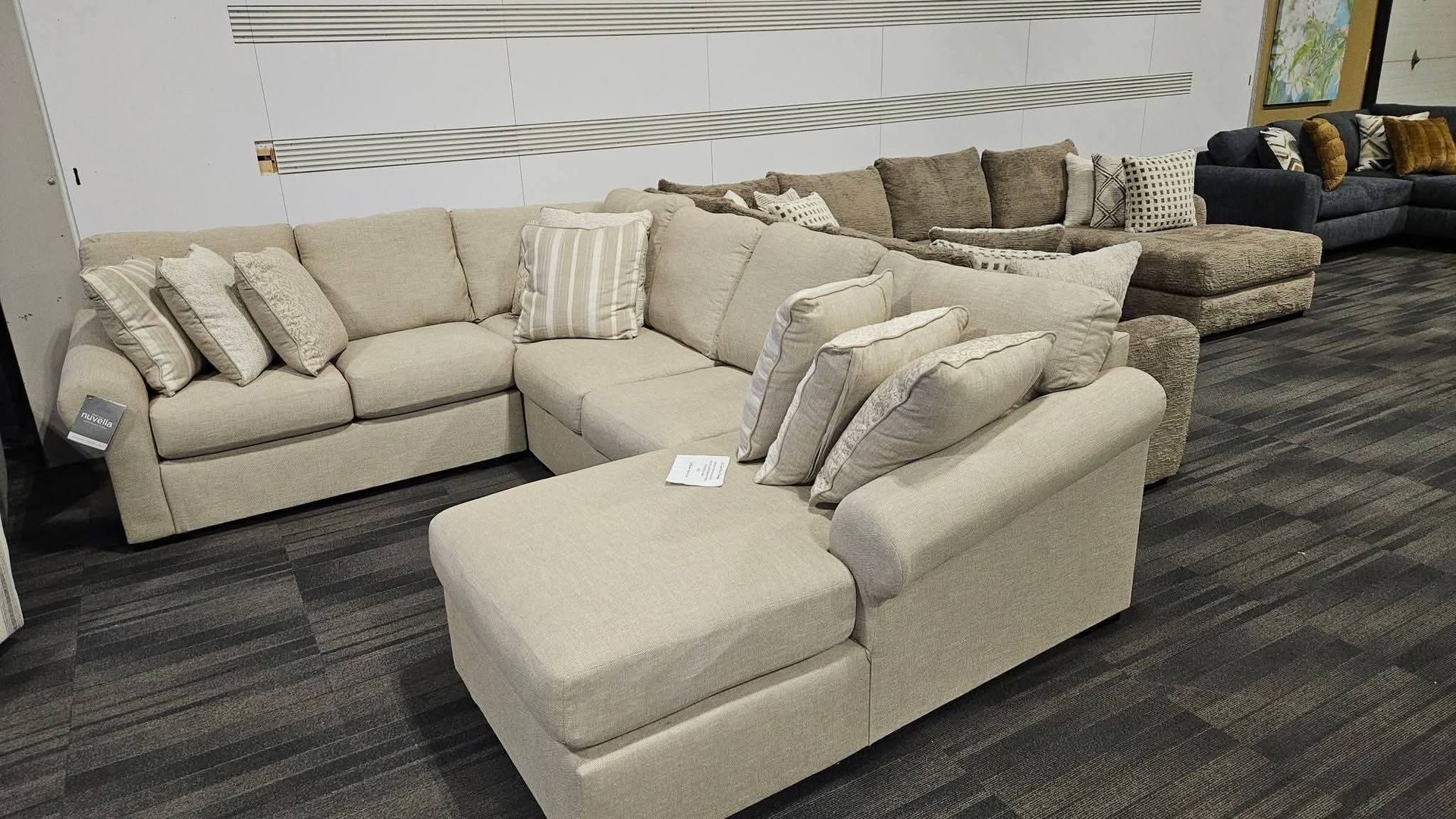 Beige sectional sofa in a furniture showroom.