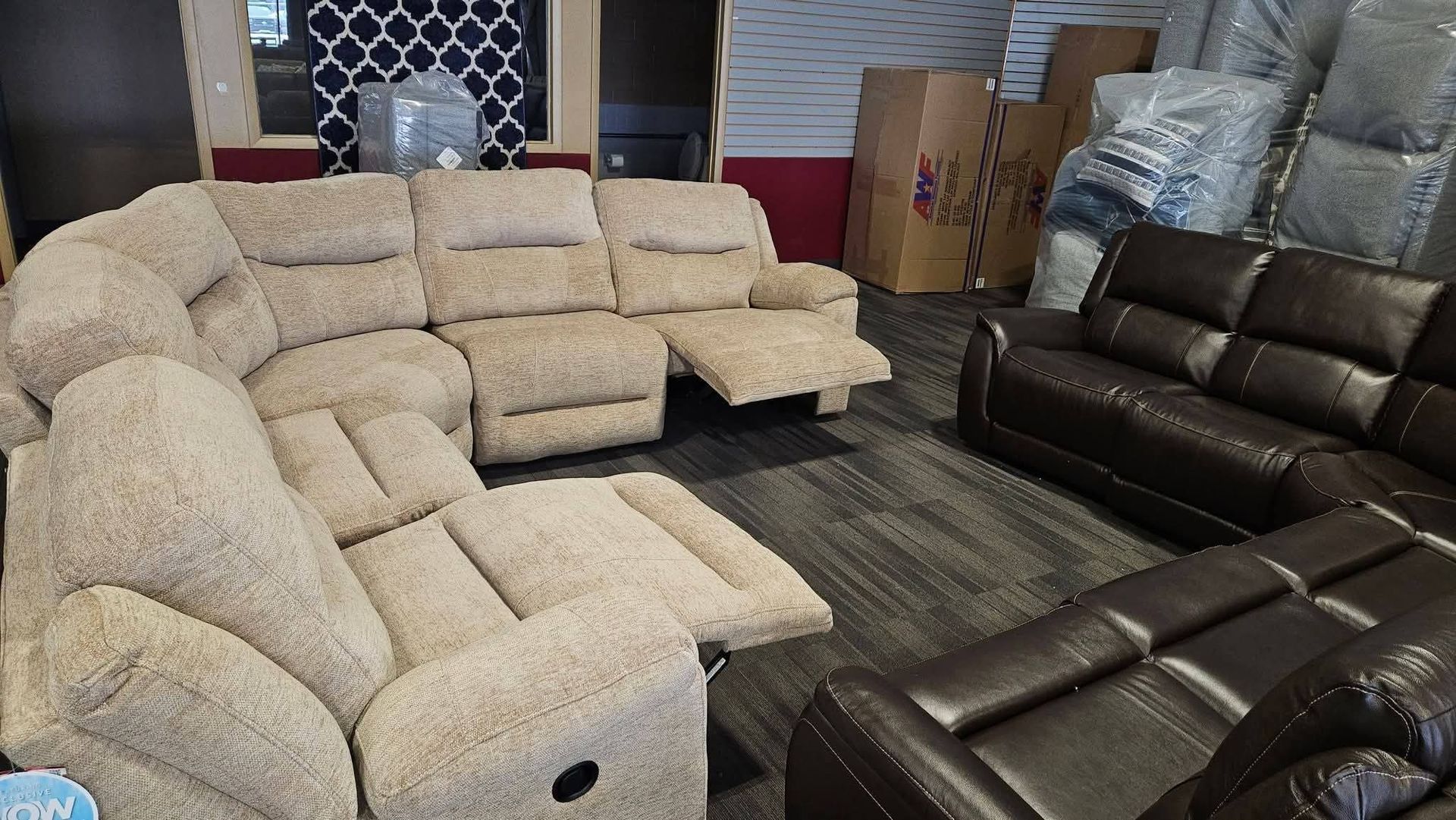 Beige reclining sectional sofa and a brown leather sofa in a room.