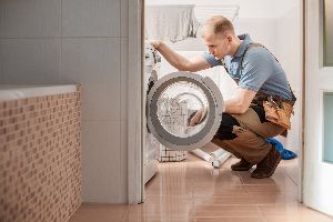 Repair Man Checking the Washing Machine — Elyria, OH — Expert Appliance Solutions Repair Man Checking the Washing Machine — Elyria, OH — Expert Appliance Solutions