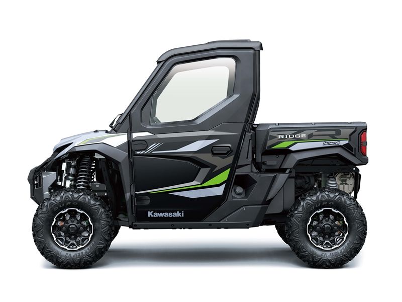 Black and silver Kawasaki utility vehicle with a covered cab and a rear cargo bed.