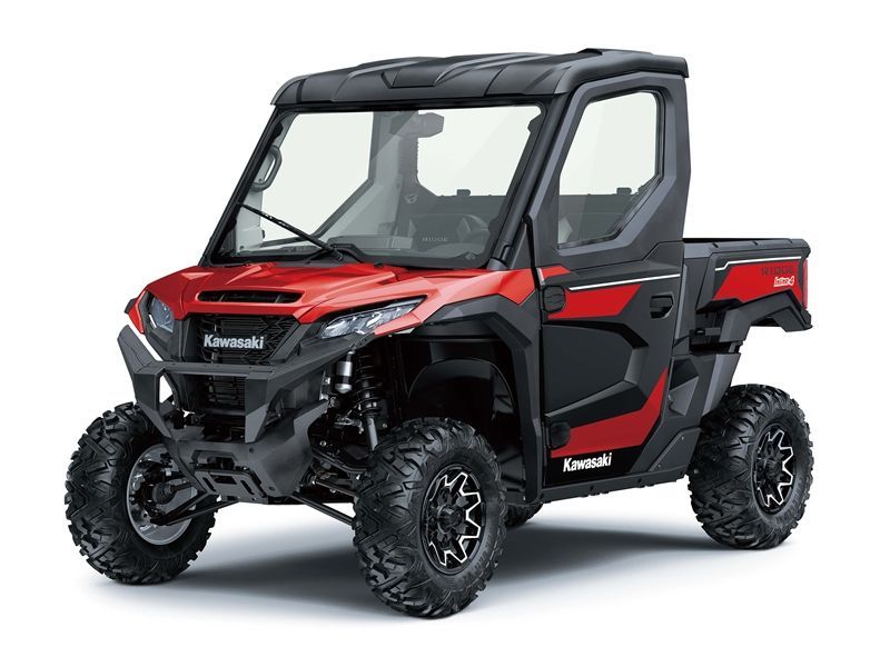 Red and black Kawasaki UTV with a cab, large tires, and a pickup bed.
