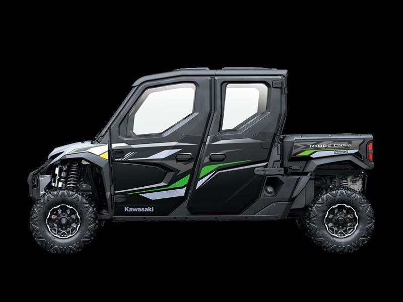 Black Kawasaki side-by-side utility vehicle with green accents against a black background.