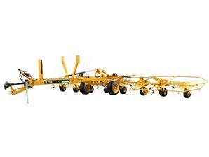 Yellow agricultural hay rake on a white background.