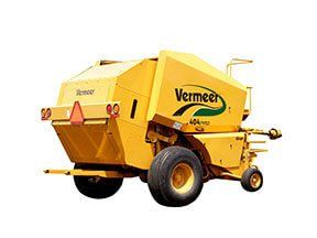 Yellow Vermeer 604 baler, agricultural equipment, outdoors.