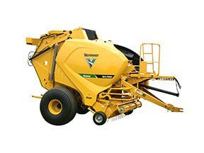 Yellow Vermeer baler machine in a field.
