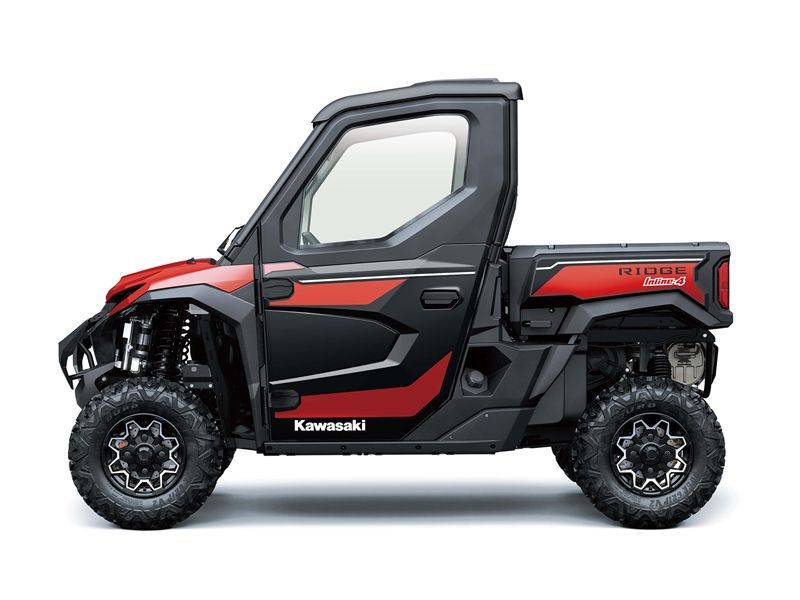 Red and black Kawasaki UTV with enclosed cab and cargo bed.