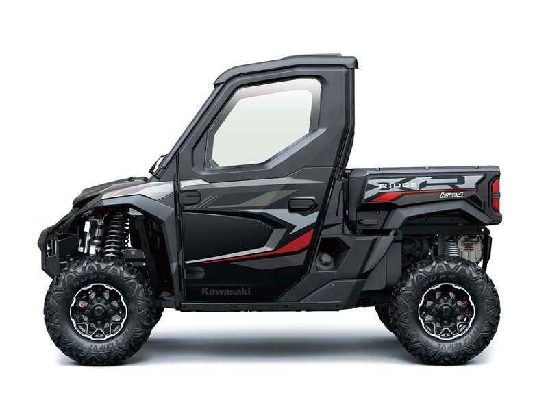 Black Kawasaki utility vehicle with red accents, large tires, and enclosed cab.