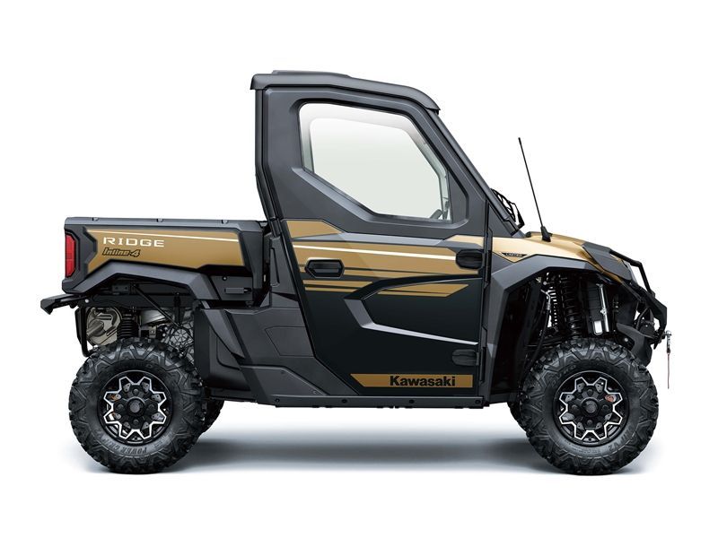 Tan and black Kawasaki Ridge side-by-side with a closed cab and a small cargo bed on a white background.