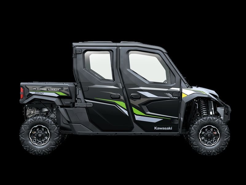 Black and green Kawasaki UTV with four doors on black background.