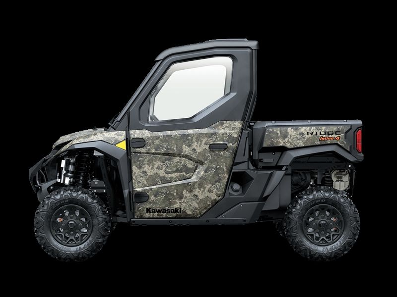 Camouflage Kawasaki Teryx side-by-side UTV with cab, black wheels, and cargo bed.