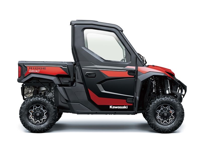 Red and black Kawasaki Ridge UTV with a cab and bed, on a white background.
