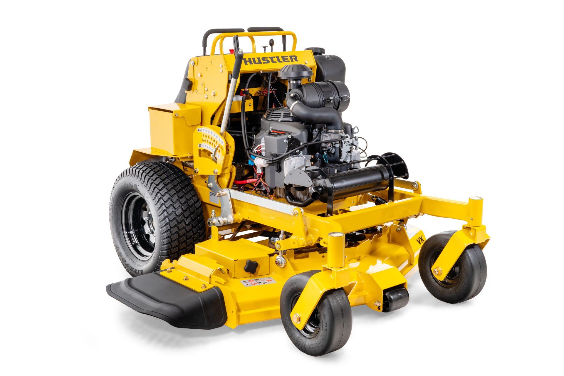 Yellow Hustler stand-on zero-turn lawn mower with black wheels and engine, on a white background.