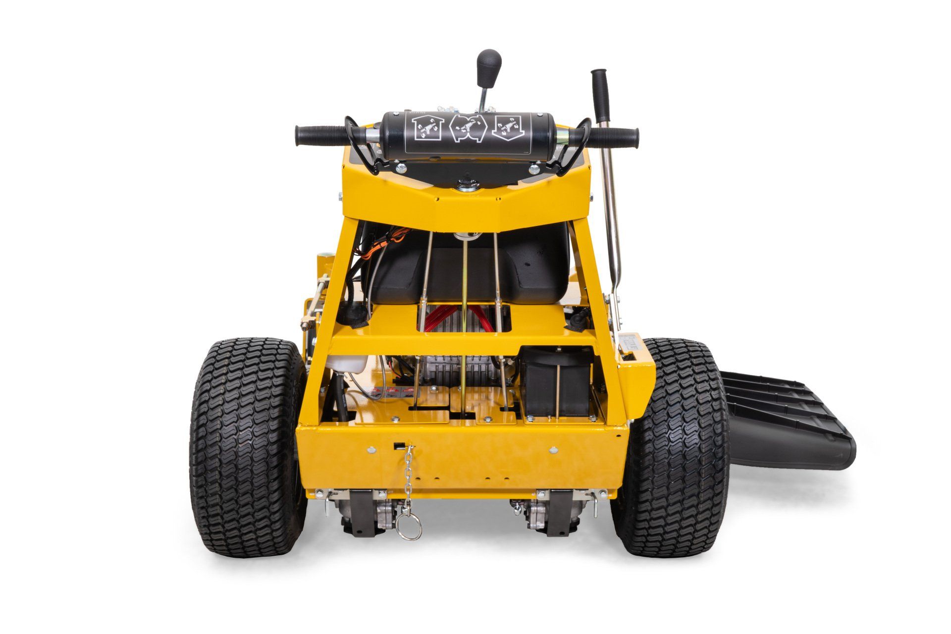 Yellow commercial lawn mower from the rear, showing tires, engine, and controls.