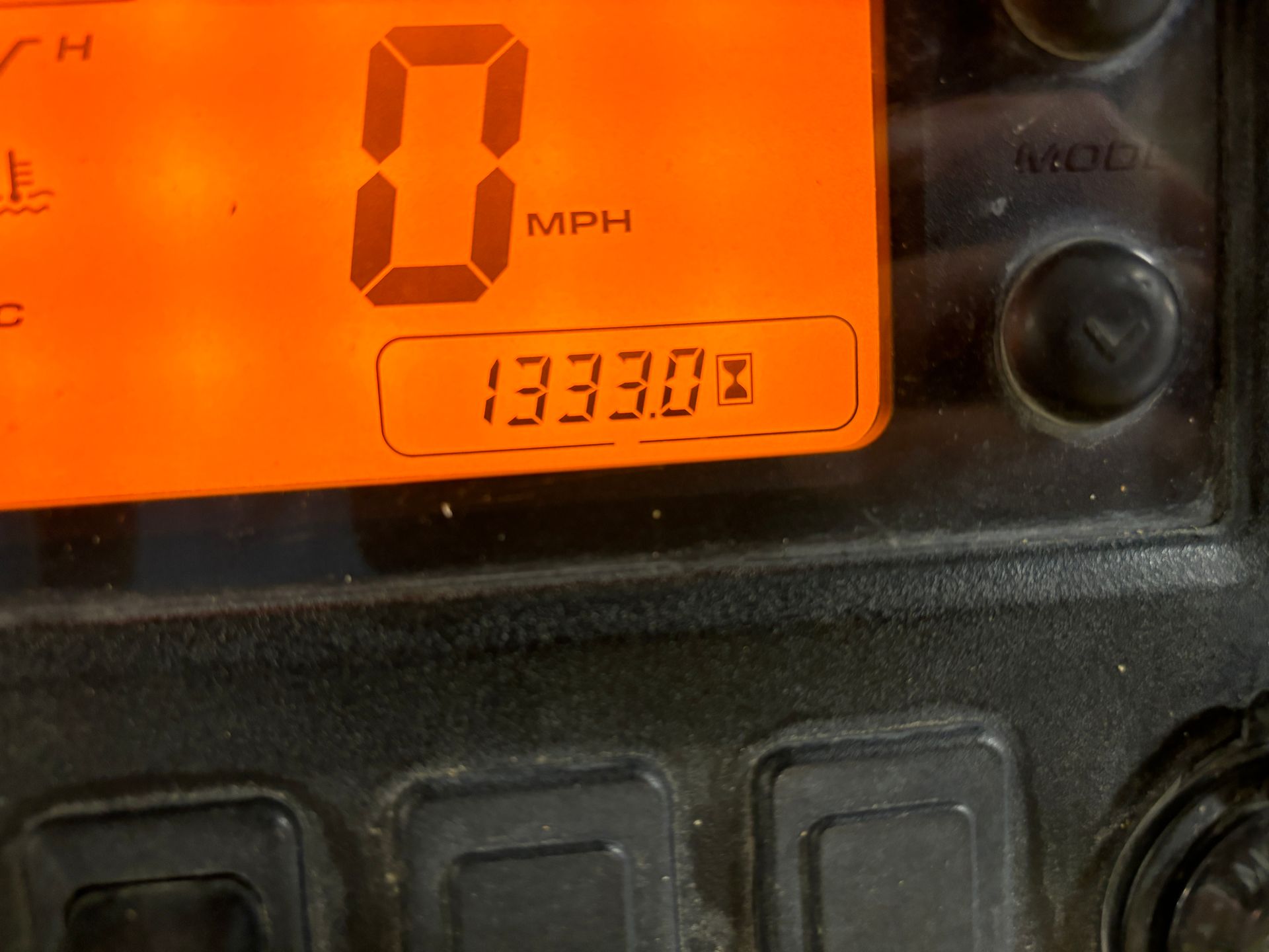 Digital display showing 0 MPH and an odometer reading of 13333.0, set against an orange background.
