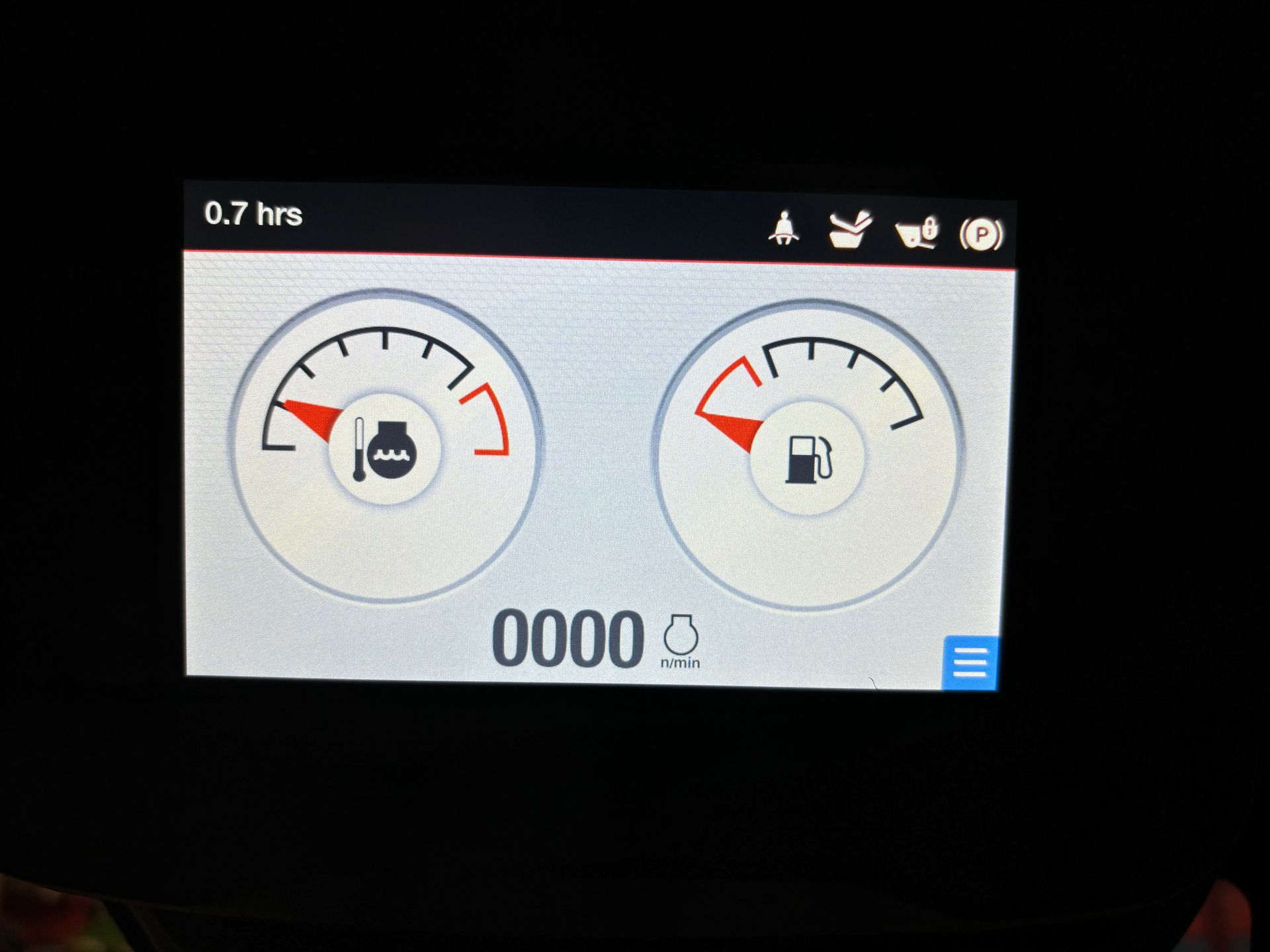 Dashboard display with gauges for fluid levels, indicating low fuel and coolant, with hour meter.