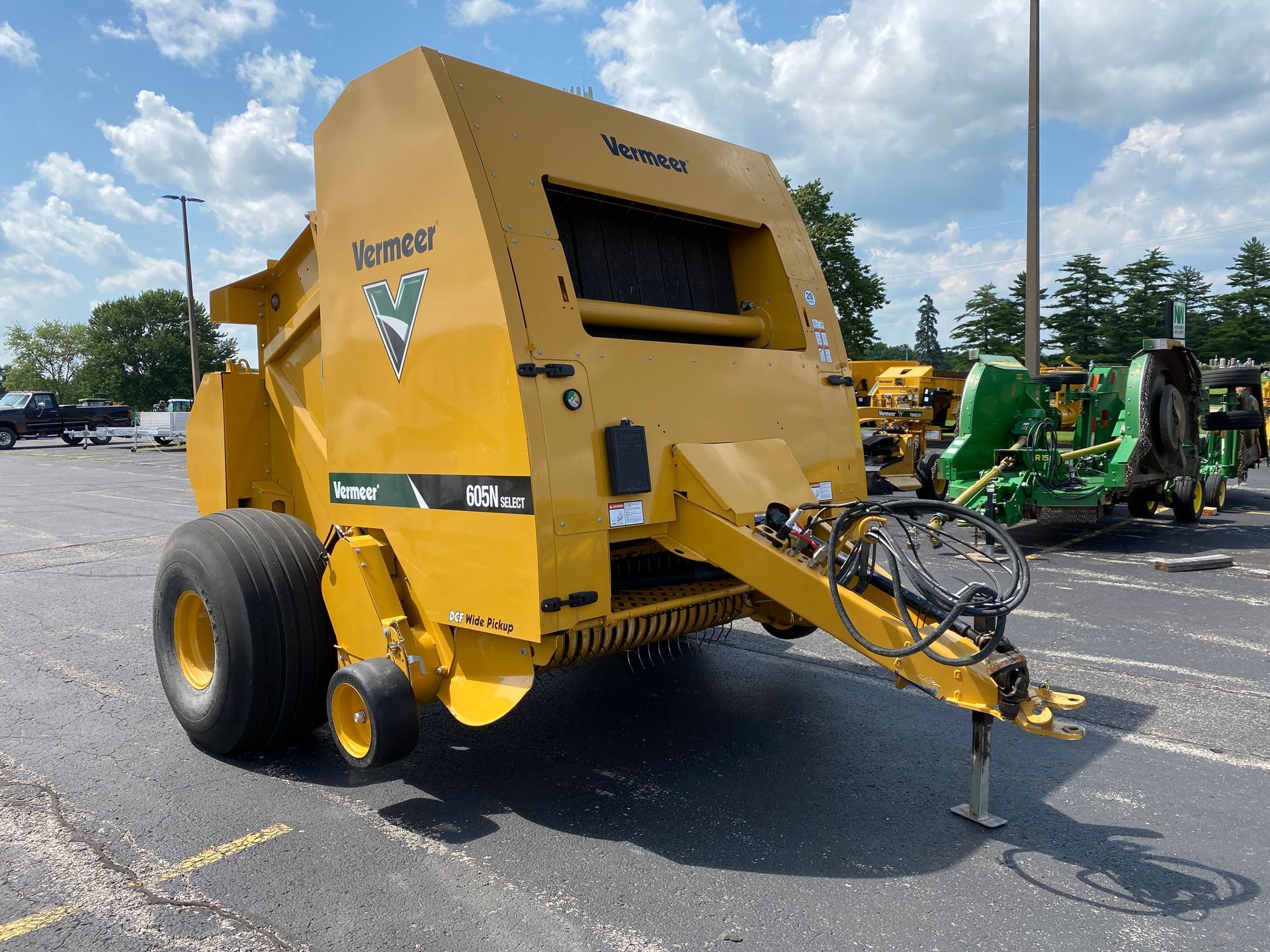 Yellow Vermeer RV560 baler in parking lot.