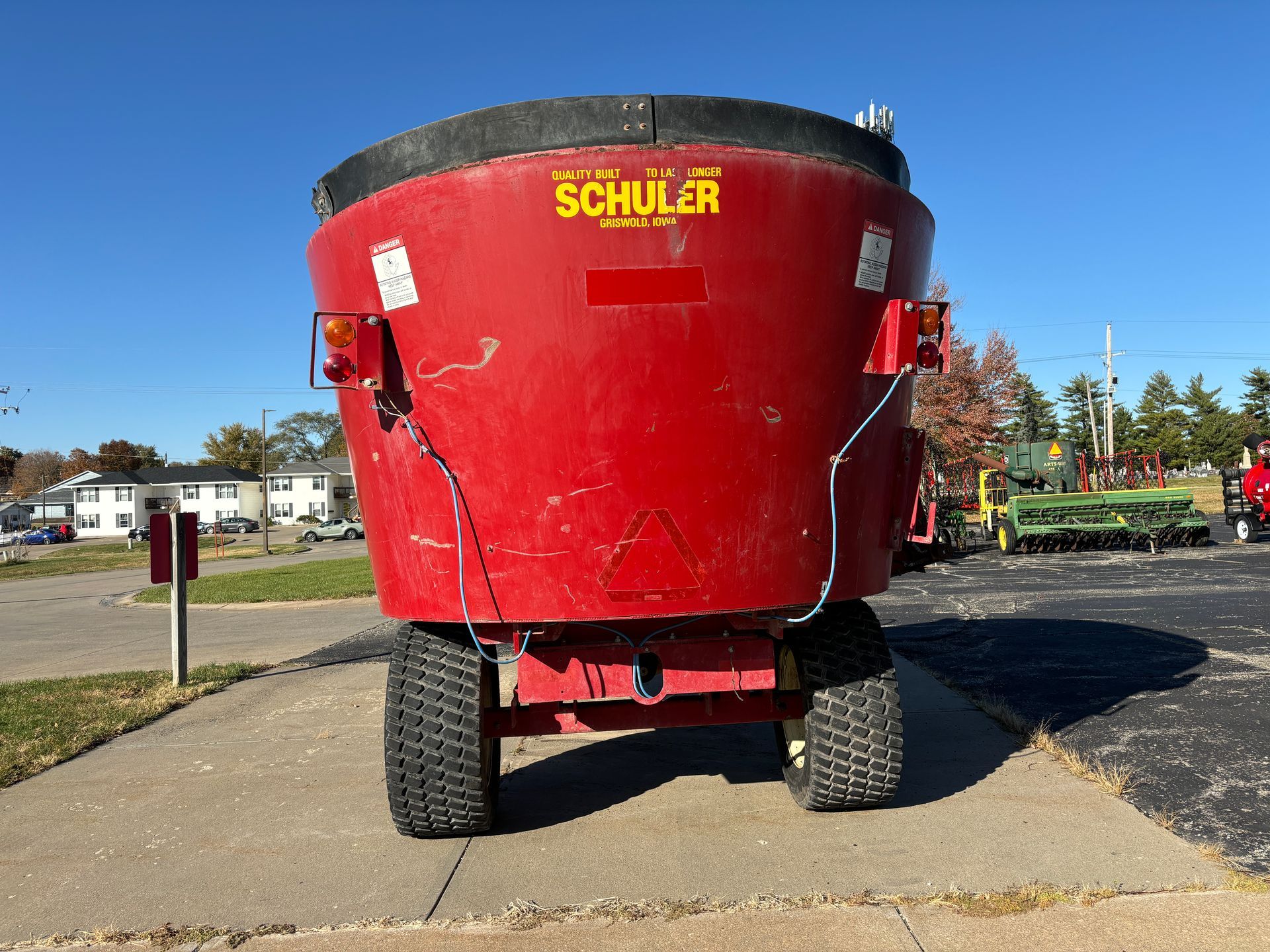 Red mixer wagon on pavement, back shot.