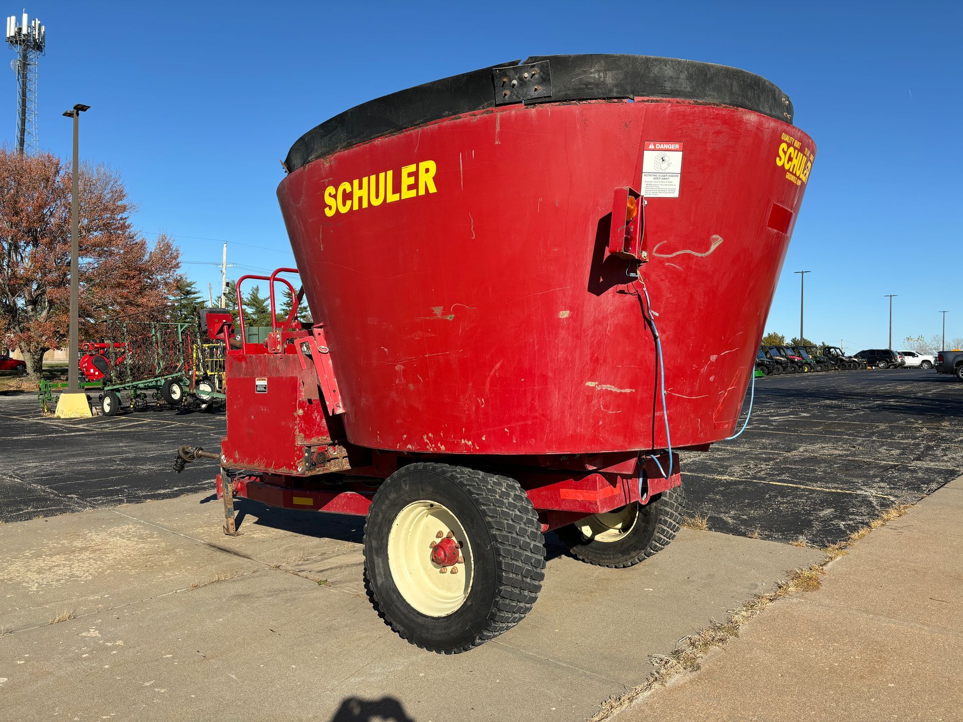 Red mixer wagon on pavement, back angled shot.