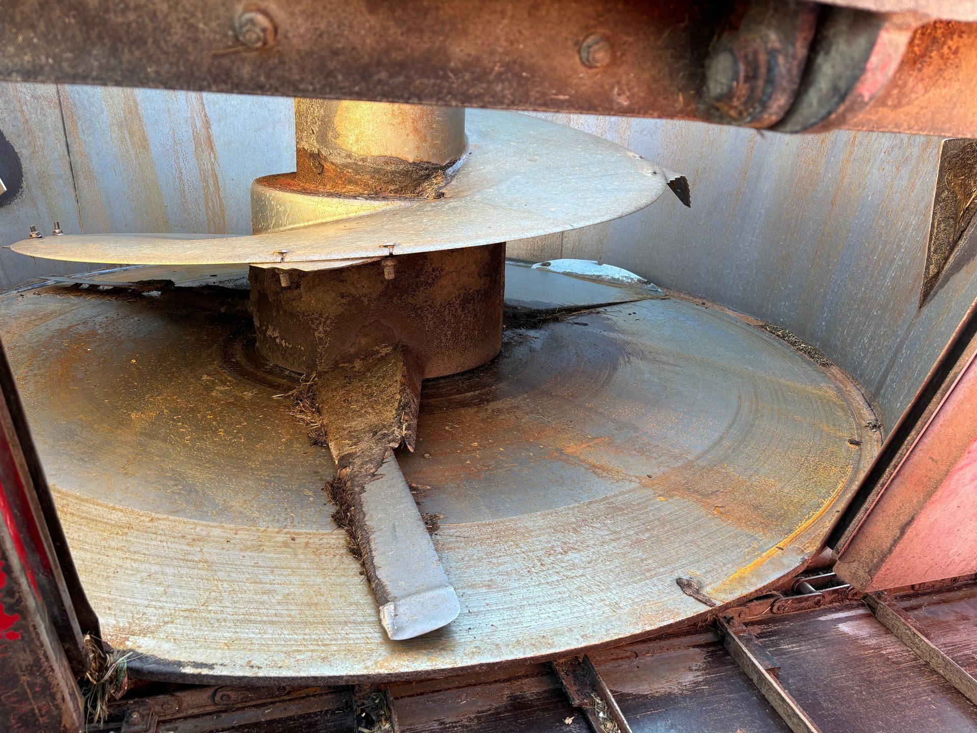 Close-up of a mixer wagon's interior, showing a rotating blade.